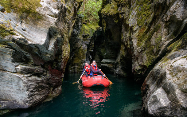 Couple paddling inflatable Funyaks on the Dart River through the hidden chasms