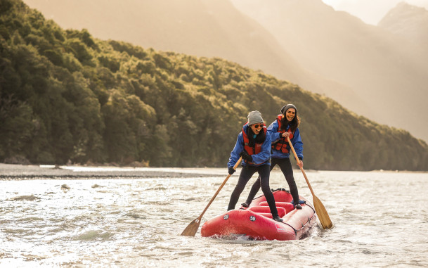 Funyak paddlers standing on their inflatable kayak on the Dart River