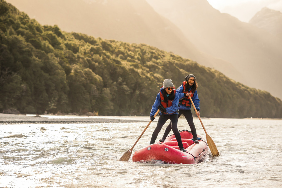 Funyak paddlers standing on their inflatable kayak on the Dart River